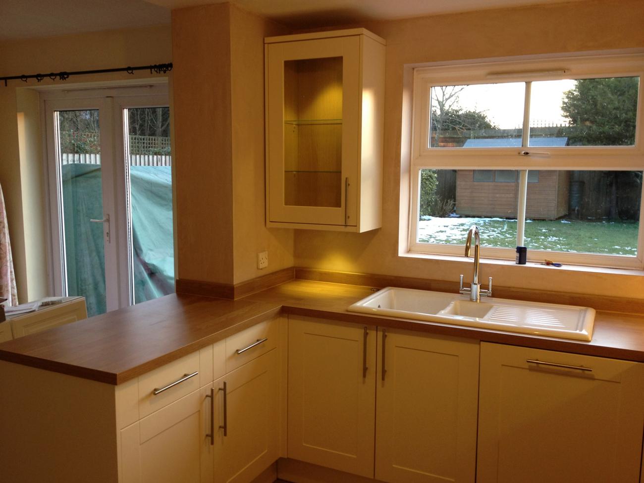 warmly lit pine worktop kitchen after refurbishment