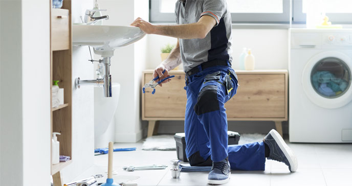 A plumber fixing a sink